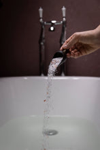 Load image into Gallery viewer, mabel + meg Fields of Tasmania bath salt being poured into a bath